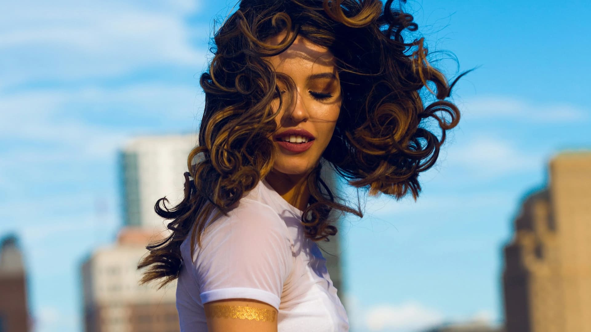 Woman smiling outdoors in morning light feeling energised and focused